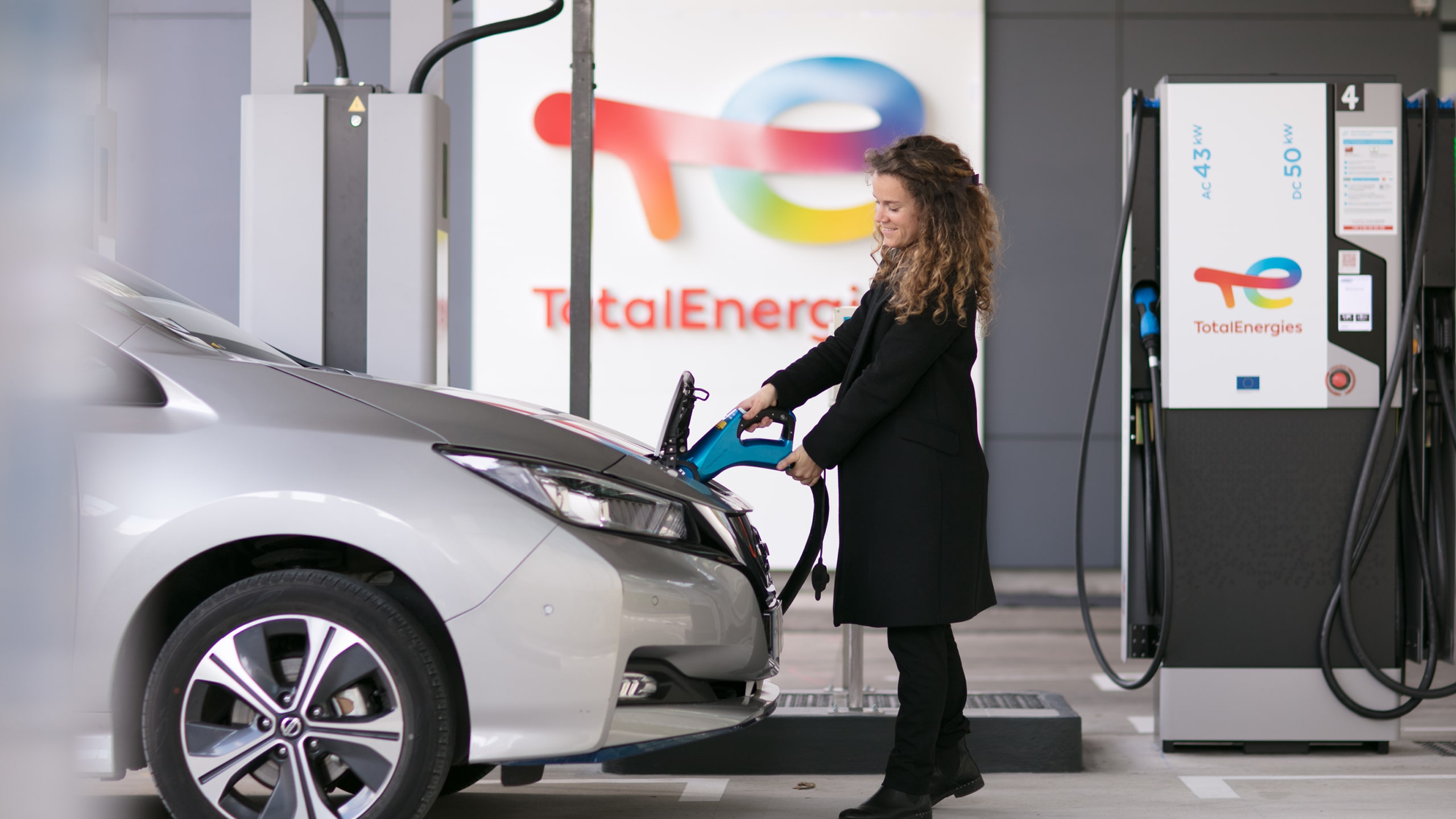 Woman charging her car